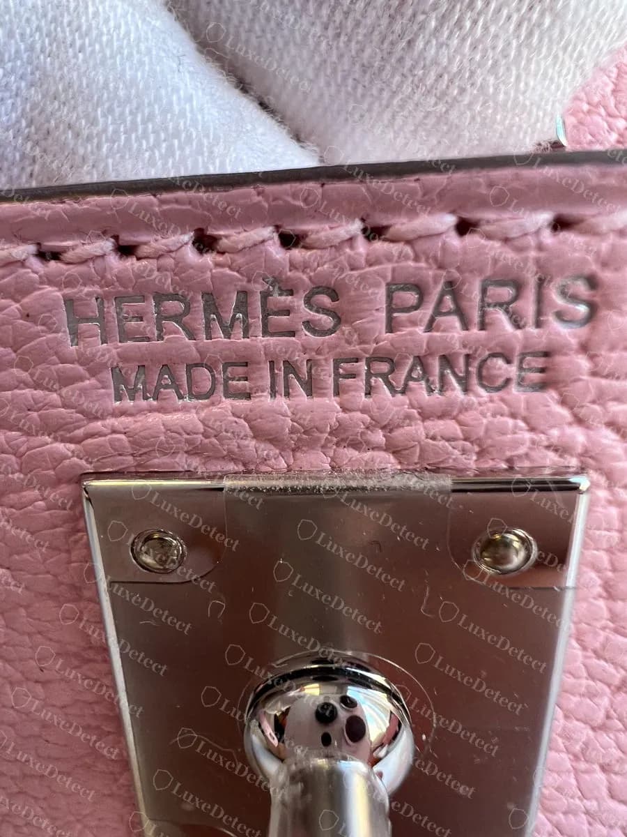 Genuine Mini Kelly II heat stamp under the flap, HERMÈS PARIS over MADE IN FRANCE, directly above the turn-lock base plate
