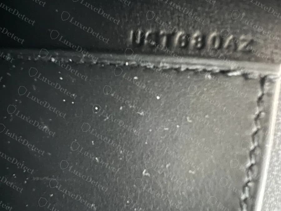 Genuine Kelly Pochette interior date and craftsman stamp, blind-embossed directly above the stitched edge of an interior panel
