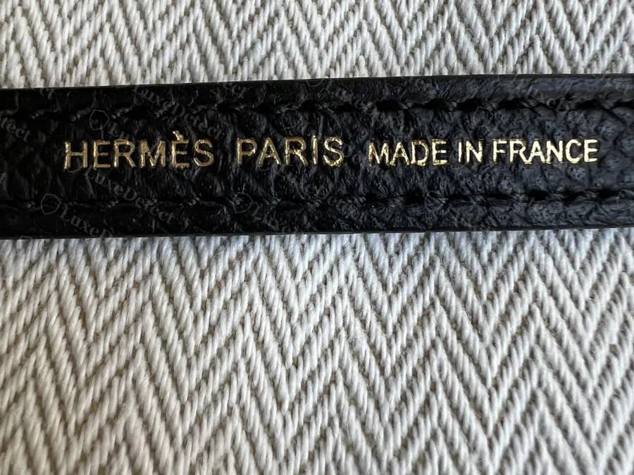 Genuine Mini Kelly II shoulder strap underside, HERMÈS PARIS MADE IN FRANCE heat-stamped in one straight line in gold foil to match gold hardware