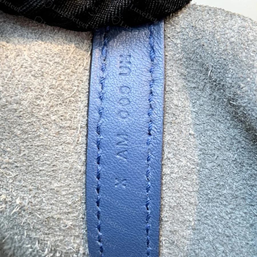 Genuine date and craftsman stamp on a Picotin strap tab, showing the two-character code and workshop number pressed into the leather