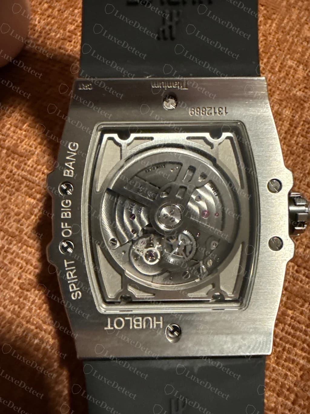 Genuine Spirit of Big Bang display back — "SPIRIT OF BIG BANG" and "HUBLOT" engraved around the sapphire, the seven-digit serial and "Titanium" engraved along the lug edge, and the HUBLOT-signed automatic movement