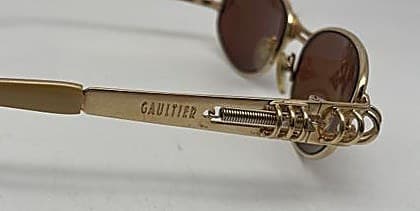 Counterfeit Jean Paul Gaultier sunglasses temple engraving reading "GAUITIER" — a missing L, a clear and decisive spelling error