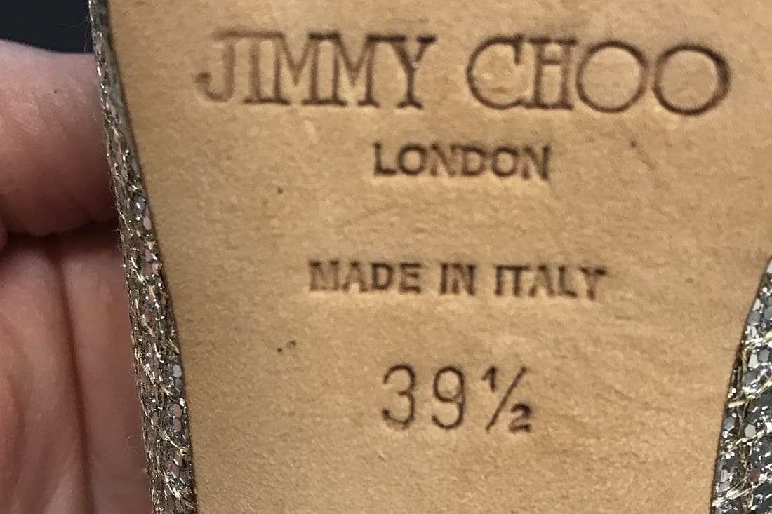 Genuine Jimmy Choo outsole stamp — "JIMMY CHOO LONDON MADE IN ITALY 39½" struck deep and clean into tan leather, every letter sharply defined