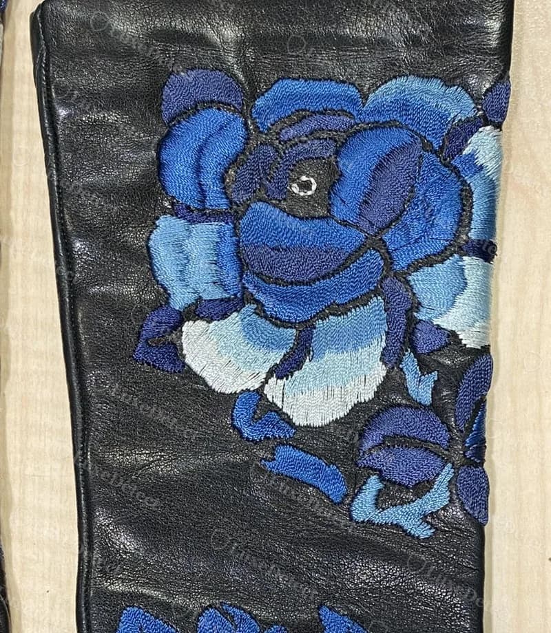 Authentic John Galliano embroidered lambskin leather glove detail, multi-tonal blue floral embroidery stitched directly into the leather.