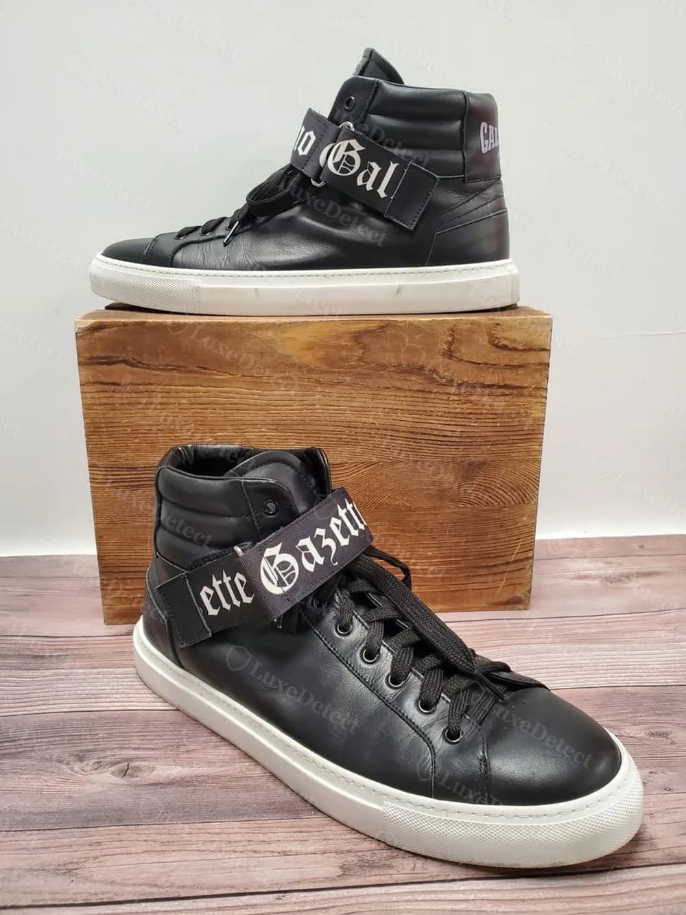 Authentic John Galliano Gazette high-top pair, blackletter "Gazette Gal..." woven strap branding split across both shoes.
