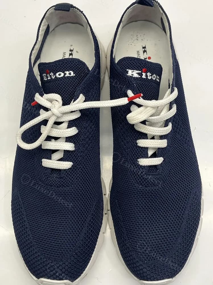 Kiton knit sneakers with an embroidered Kiton wordmark on the tongue, red dot detail, and matching debossed sole branding