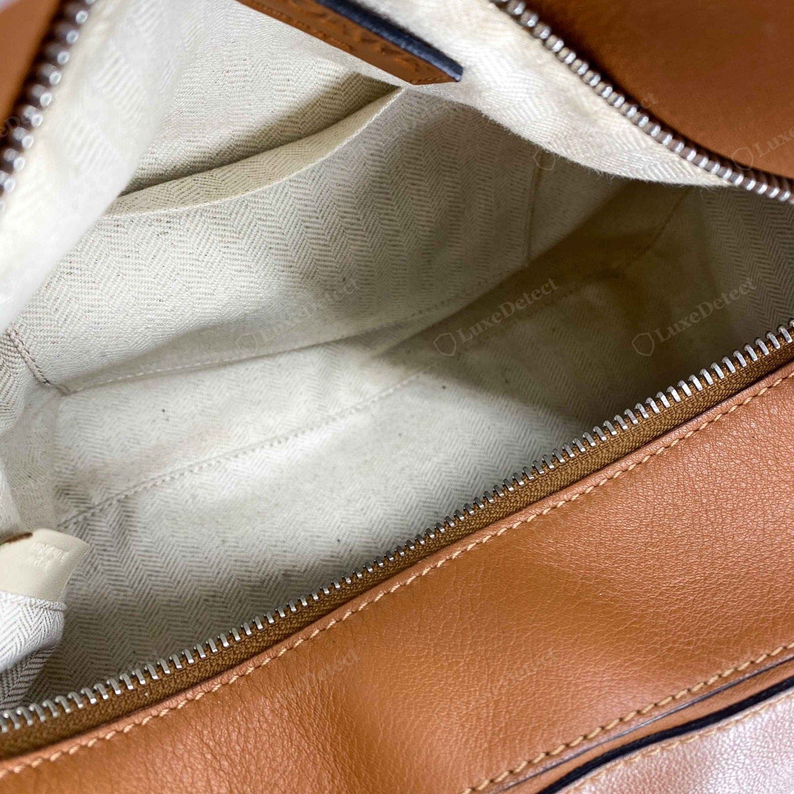 Genuine Loewe Puzzle interior — even soft suede lining coordinating with the exterior, the sewn-in label straight and clean