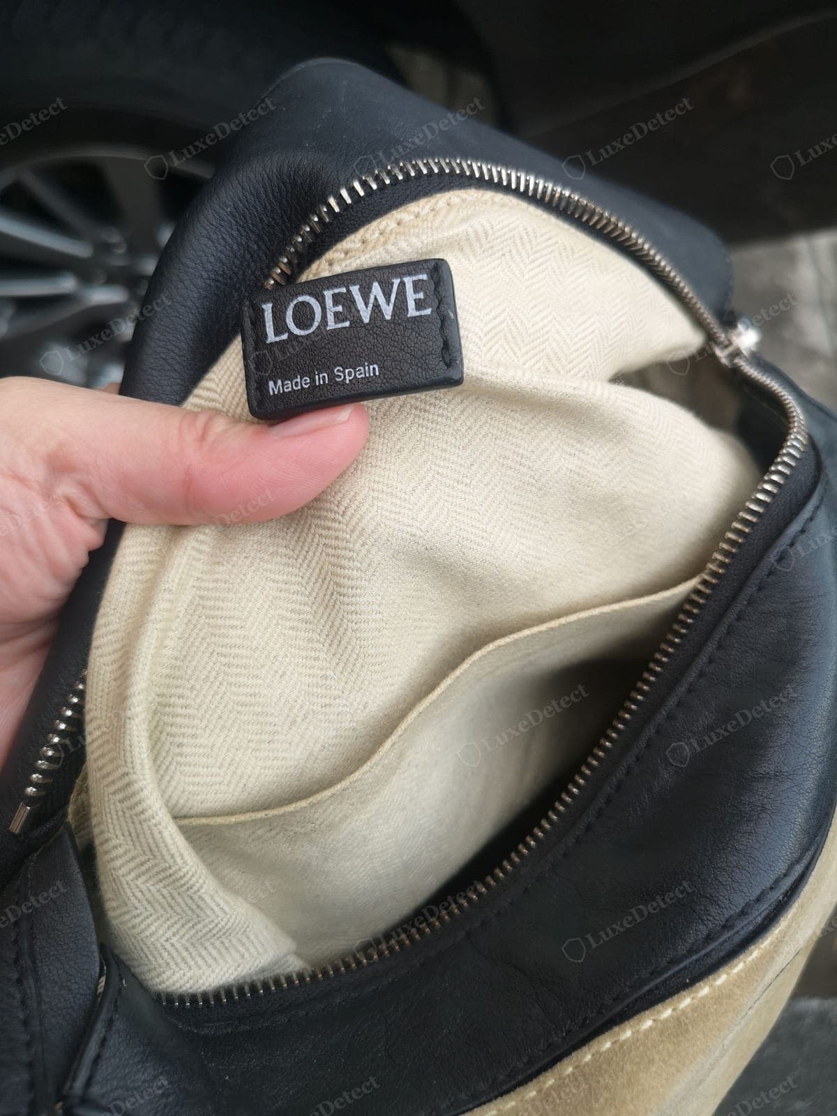 Counterfeit Loewe Puzzle stamp and label — a clumsy or wrong-font emboss, a code in the wrong format, stiff or plasticky leather