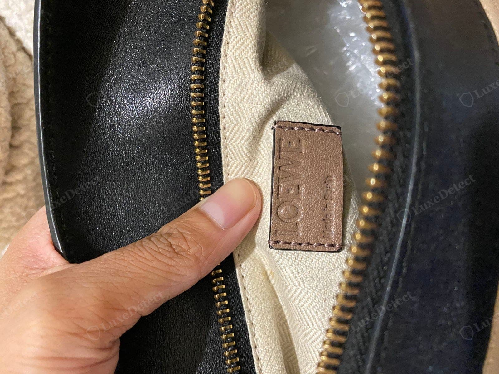 Genuine Loewe Puzzle heat stamp and label — "LOEWE" and "MADE IN SPAIN" cleanly embossed on soft even calfskin, with the reference code