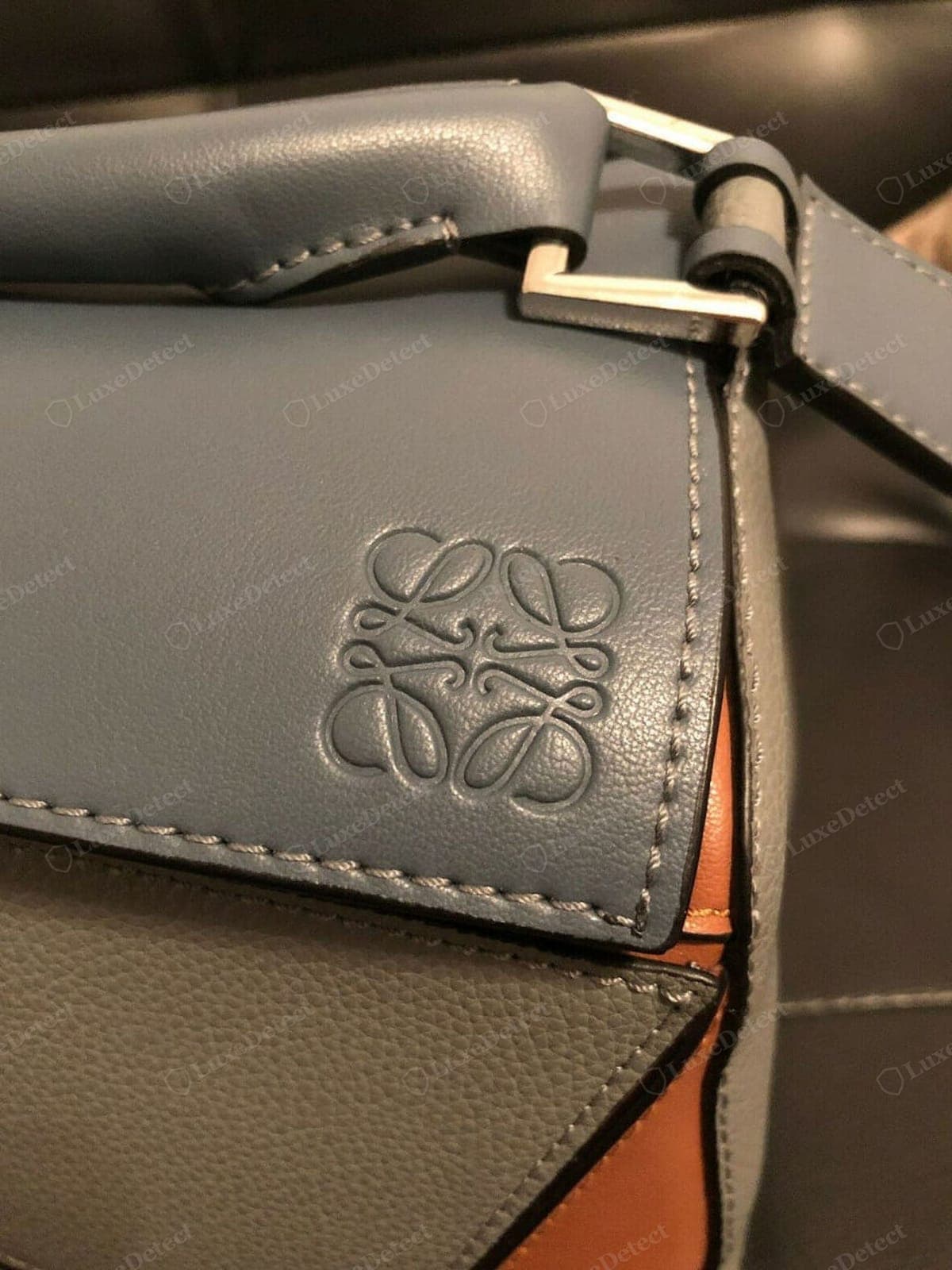 Counterfeit Loewe Puzzle stitching — uneven stitch length and tension, wandering seam lines, loose or gappy at the panel points