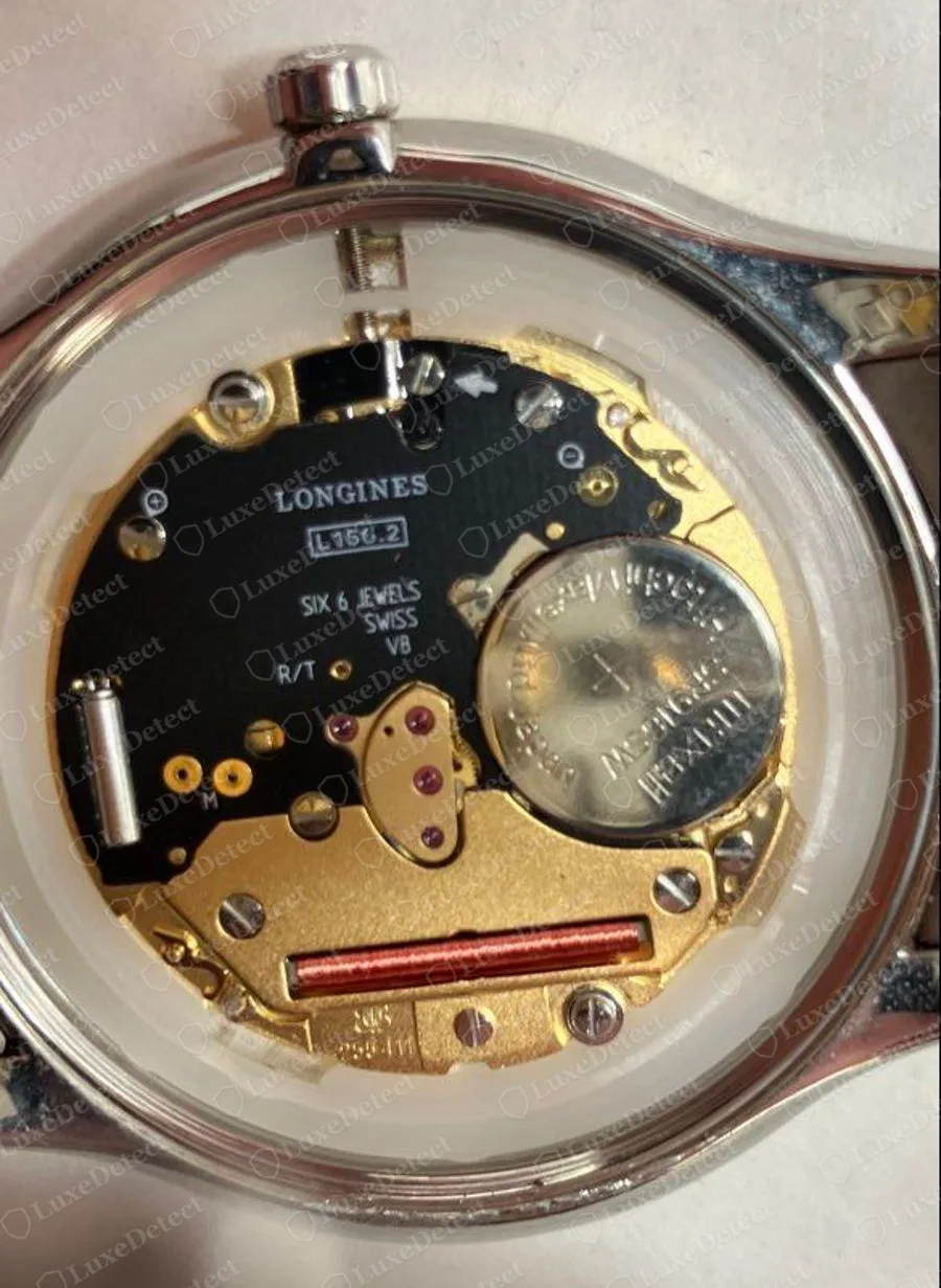 Genuine Longines quartz movement seen through an open caseback, black plate printed LONGINES with a calibre-style code and SIX 6 JEWELS SWISS, a coil and a battery