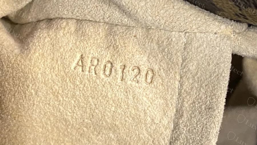 Genuine Artsy with the date code AR0120 stamped into the suede-like lining