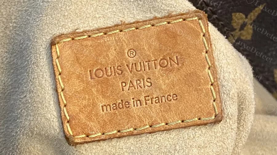 Genuine, well-worn Artsy interior tag reading made in France, with darkened leather