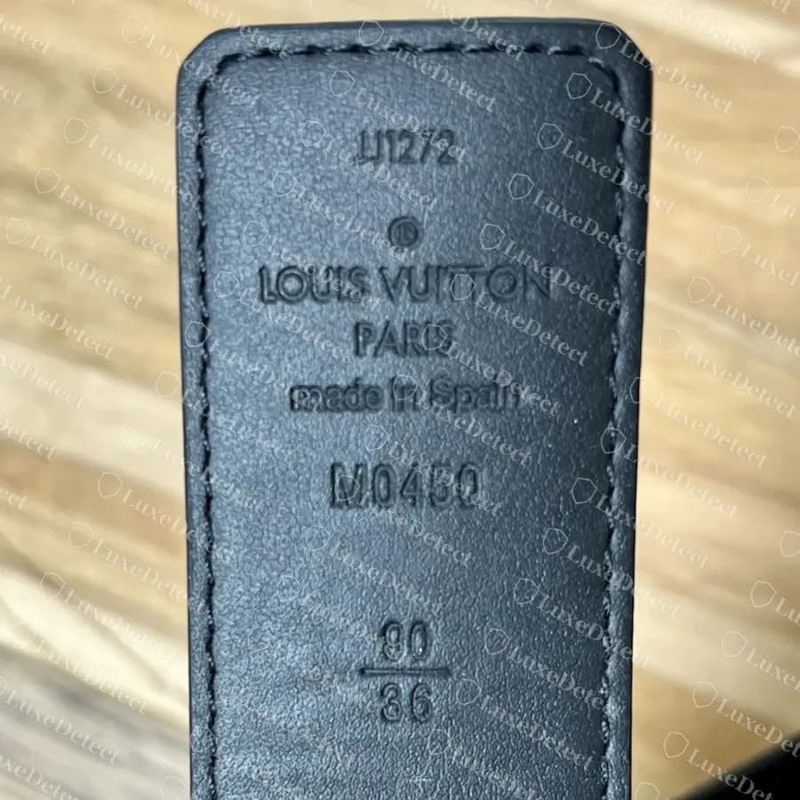 Counterfeit reversible LV belt tip with a full copied stamp block: date code, LOUIS VUITTON PARIS made in Spain, model number M0450 and a 90 over 36 size