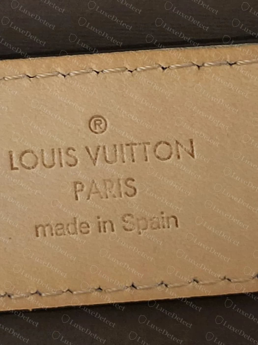 Genuine Louis Vuitton belt heat stamp on natural leather: circle R, LOUIS VUITTON, PARIS, made in Spain in thin, even lettering