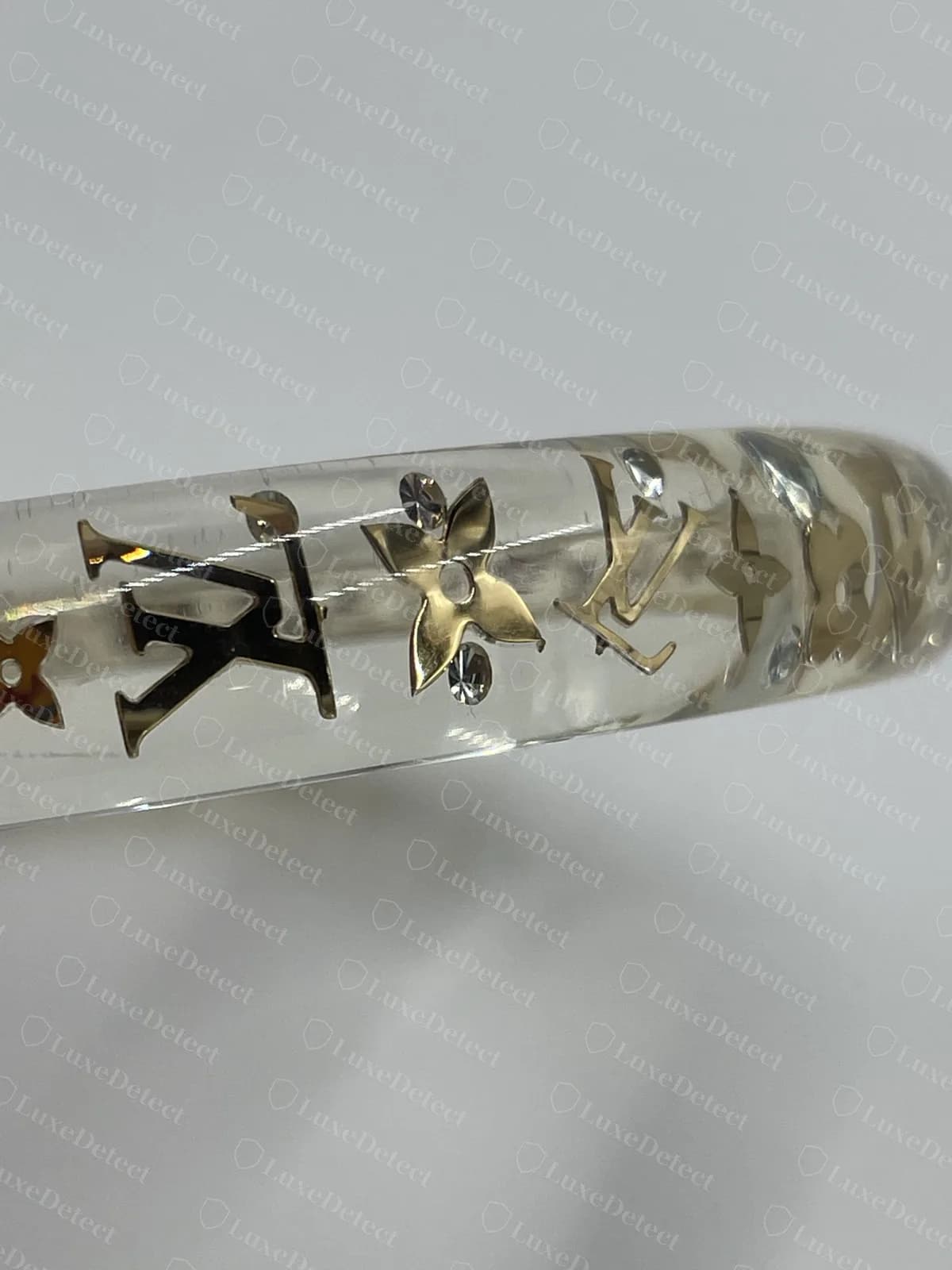 Authentic Inclusion bangle with gold-tone Monogram flowers and LV initials set inside clear resin