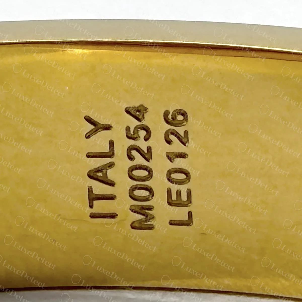 A second counterfeit from a different seller, stamped ITALY / M00254 / LE0126, the same date code seen across eight fakes