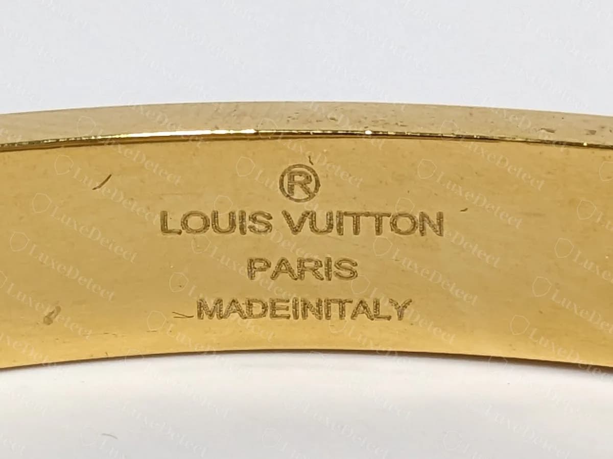 Counterfeit bangle signed LOUIS VUITTON PARIS with the origin line run together as MADEINITALY