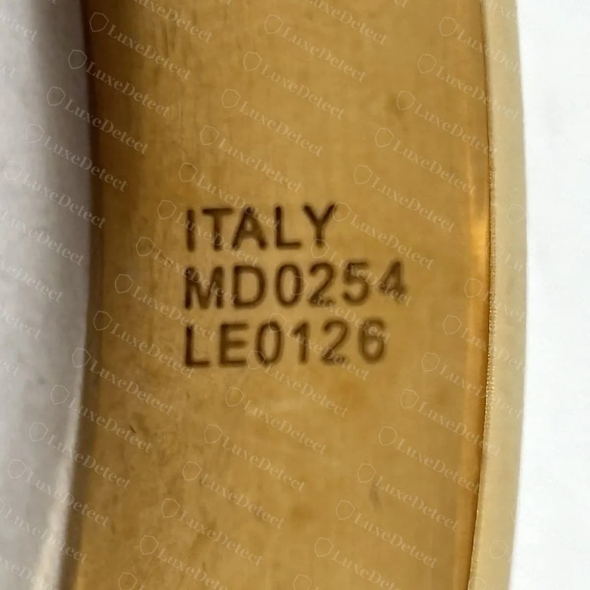 Counterfeit Nanogram-style cuff stamped ITALY / MD0254 / LE0126, the letter D standing in for a zero and the characters large and heavy