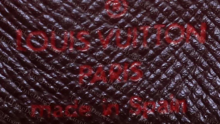 Genuine Damier Ebene Musette Tango: red heat stamp on the flap lining reading LOUIS VUITTON PARIS made in Spain