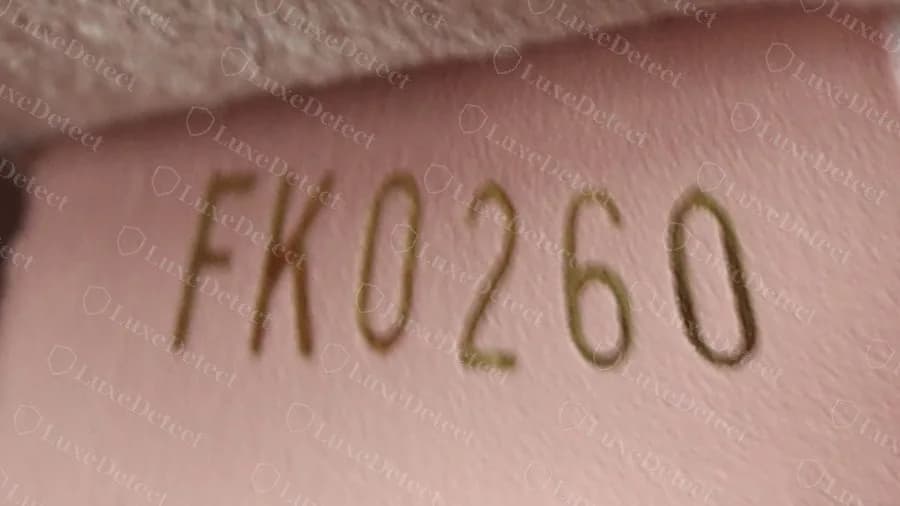 Genuine Neonoe date code FK0260 stamped in gold on a pale pink leather tab
