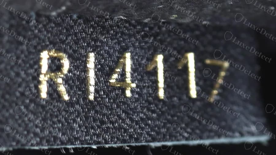 Genuine Neonoe date code RI4117 stamped in gold on a black woven fabric tab