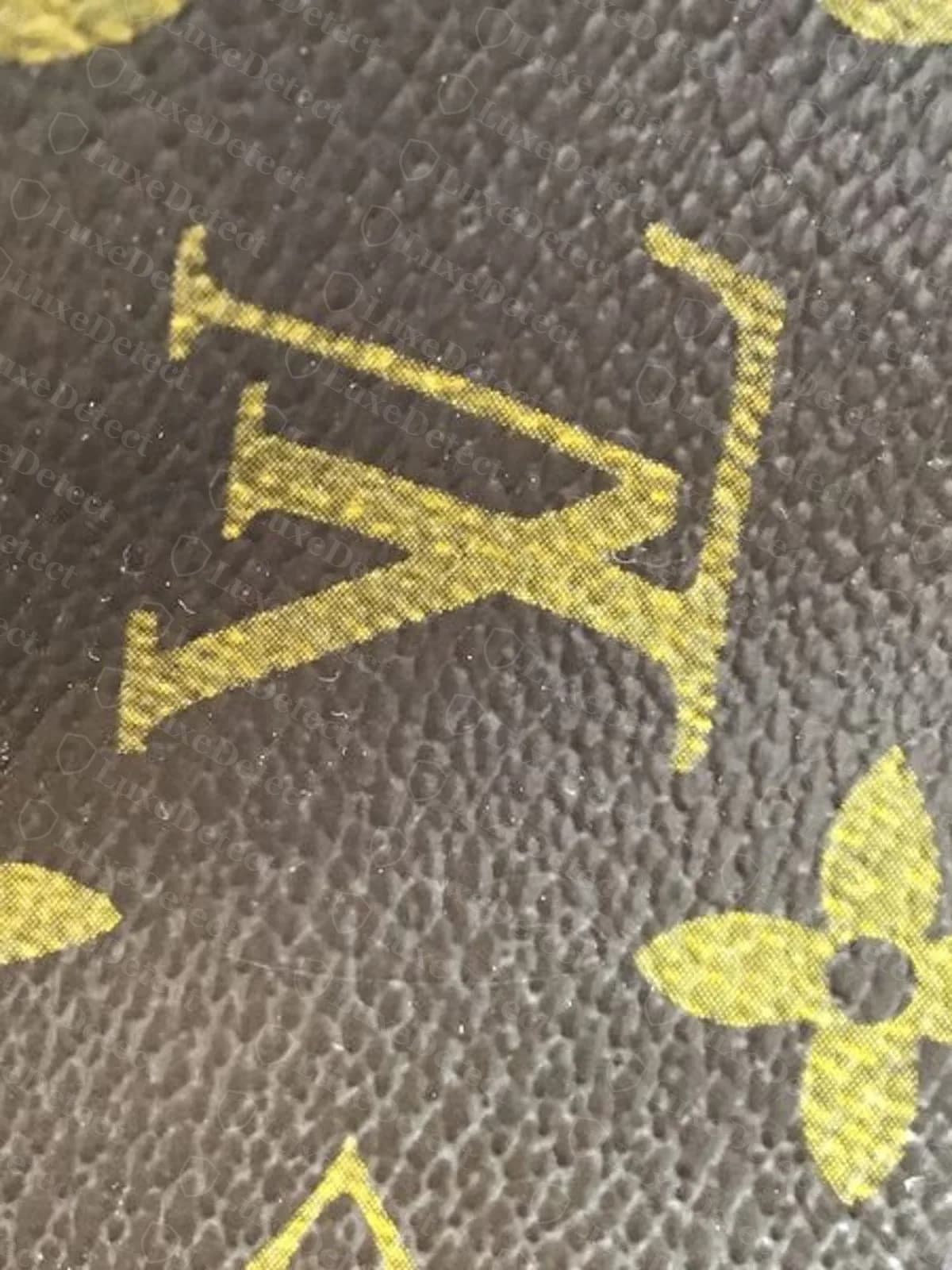 Fake Petit Noé monogram canvas base panel, the "LV" motif at center printing as a mirror image next to correctly-oriented motifs around it.