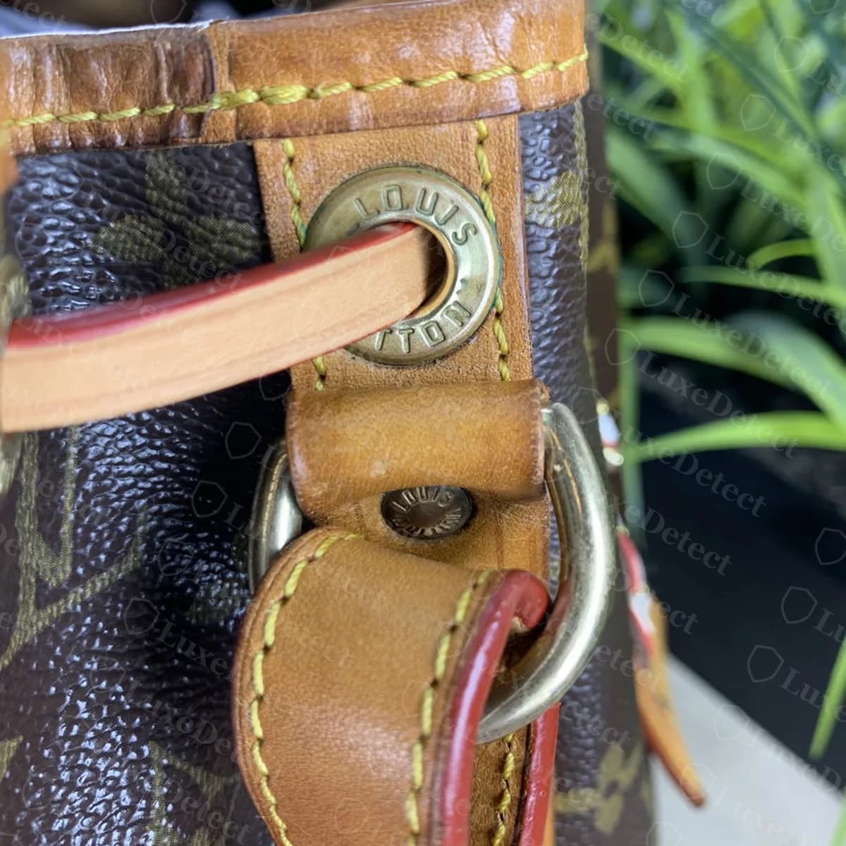 Authentic Noé rivet and D-ring stamp, "LOUIS VUITTON" reading correctly all the way around with no mirroring.