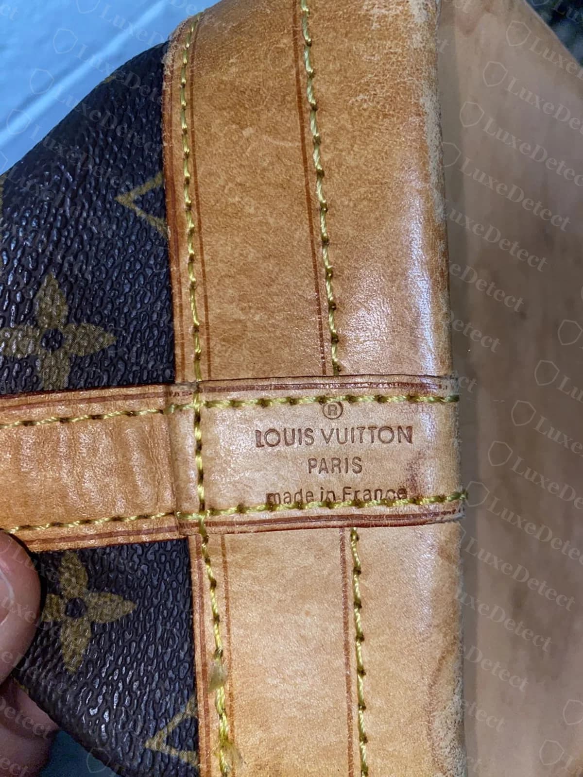 Fake Noé heat stamp, "LOUIS VUITTON PARIS made in France" with cramped letter spacing and the lines sitting close together.