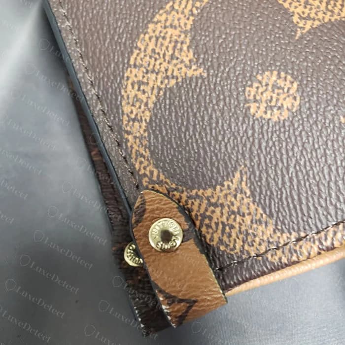Corner seam on a confirmed counterfeit OnTheGo in a seasonal print, showing a less precise fold at the panel join