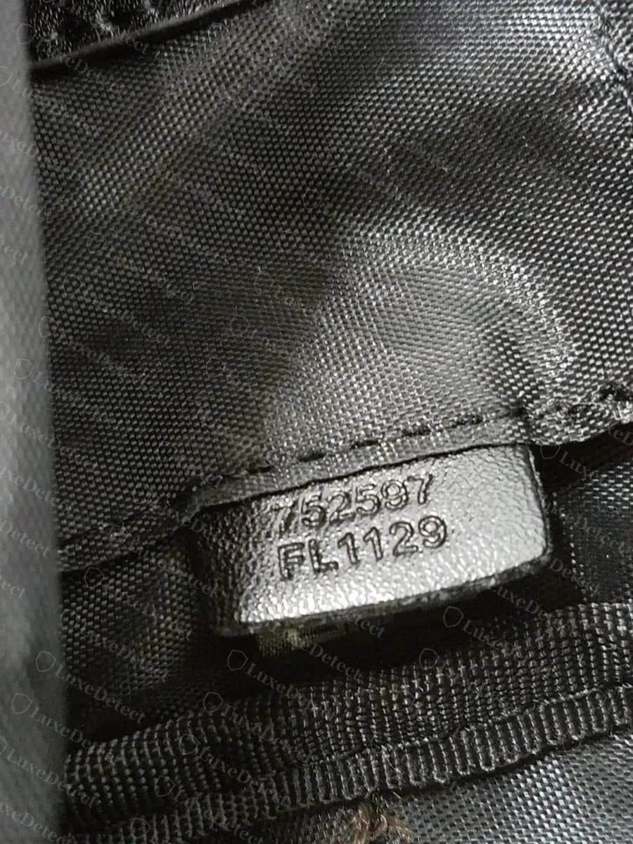 Counterfeit Reverse Palm Springs Mini tab stamped with an extra number line above FL1129, on a shiny plain-weave nylon lining