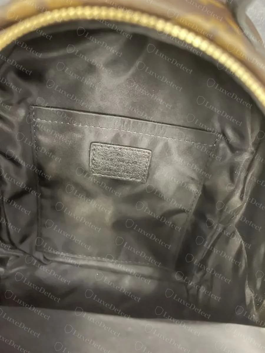 Counterfeit Palm Springs Mini interior: glossy, crinkled satin-style lining with no twill weave, and a small interior patch