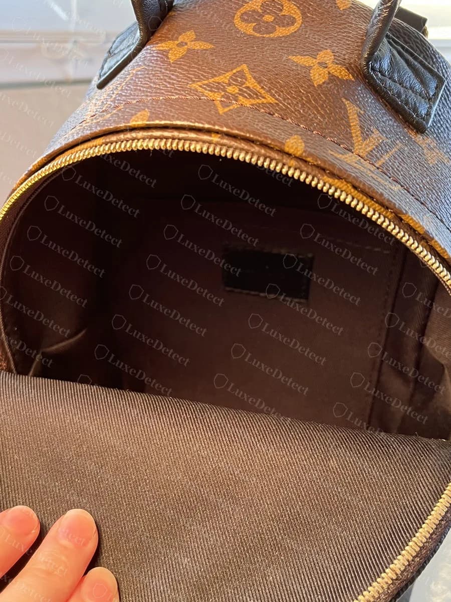 Genuine RFID-era Palm Springs Mini interior: dark brown twill lining and the leather heat-stamp patch, with no date code tab