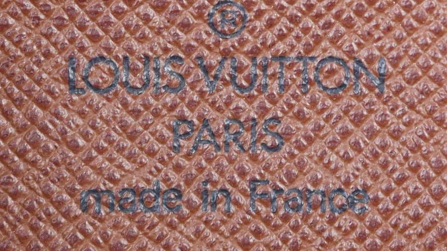 Genuine Papillon lining: the registered mark, LOUIS VUITTON, PARIS and made in France heat-stamped straight into the brown lining
