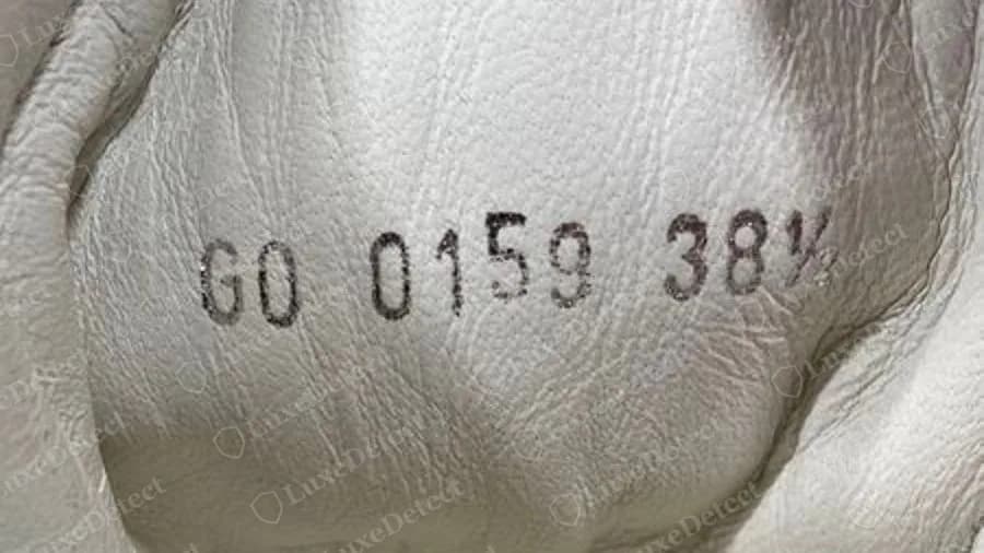 Counterfeit Louis Vuitton sneaker with a correctly formatted stamp, GO 0159 38½, which copies the genuine layout