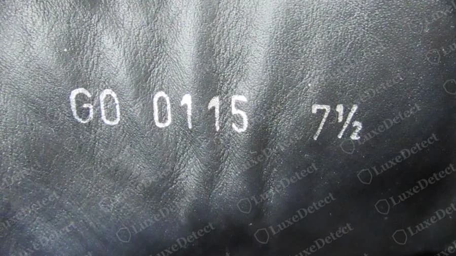 Genuine Louis Vuitton sneaker stamp pressed in white on black leather: GO 0115 7½, two letters, four digits, then the size