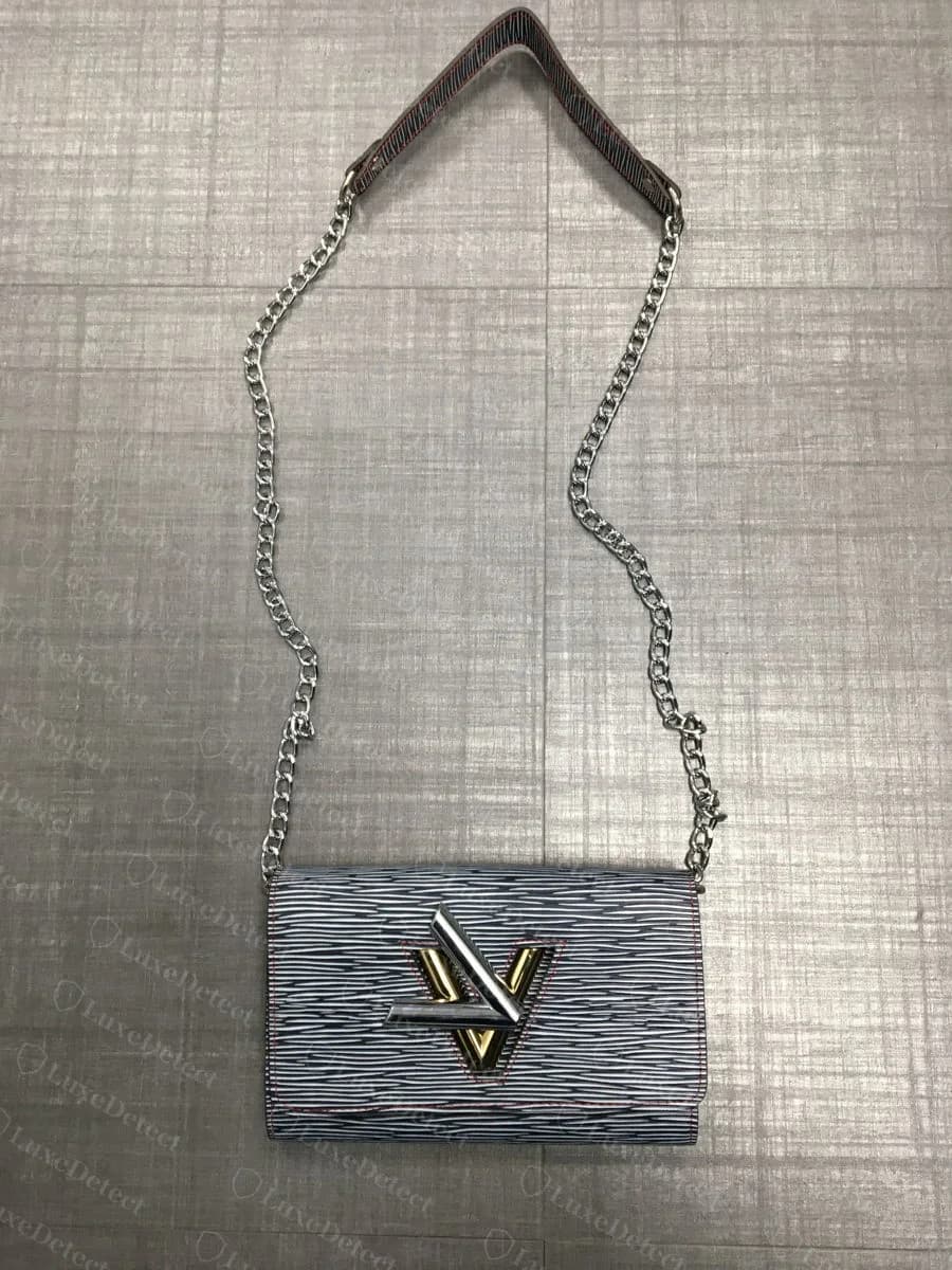 A counterfeit Twist bag in a zebra-pattern colorway — the pattern is printed flat onto smooth leather with no raised Epi texture, and the exposed red stitching thread is a second tell on the same bag
