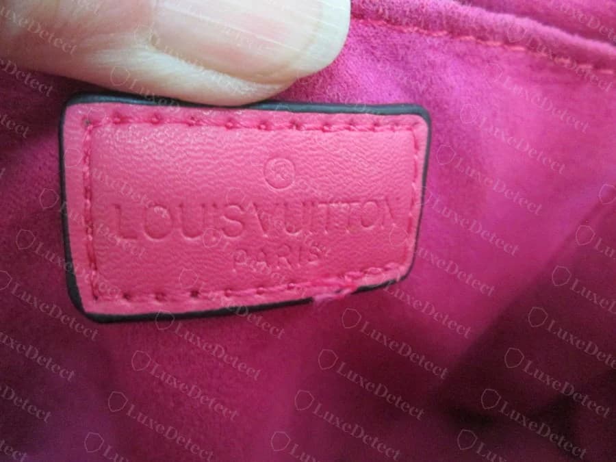 Interior stamp from a counterfeit Twist bag in our archive — the words are run together with no space, "made in France" is missing, and the leather panel has no Epi texture