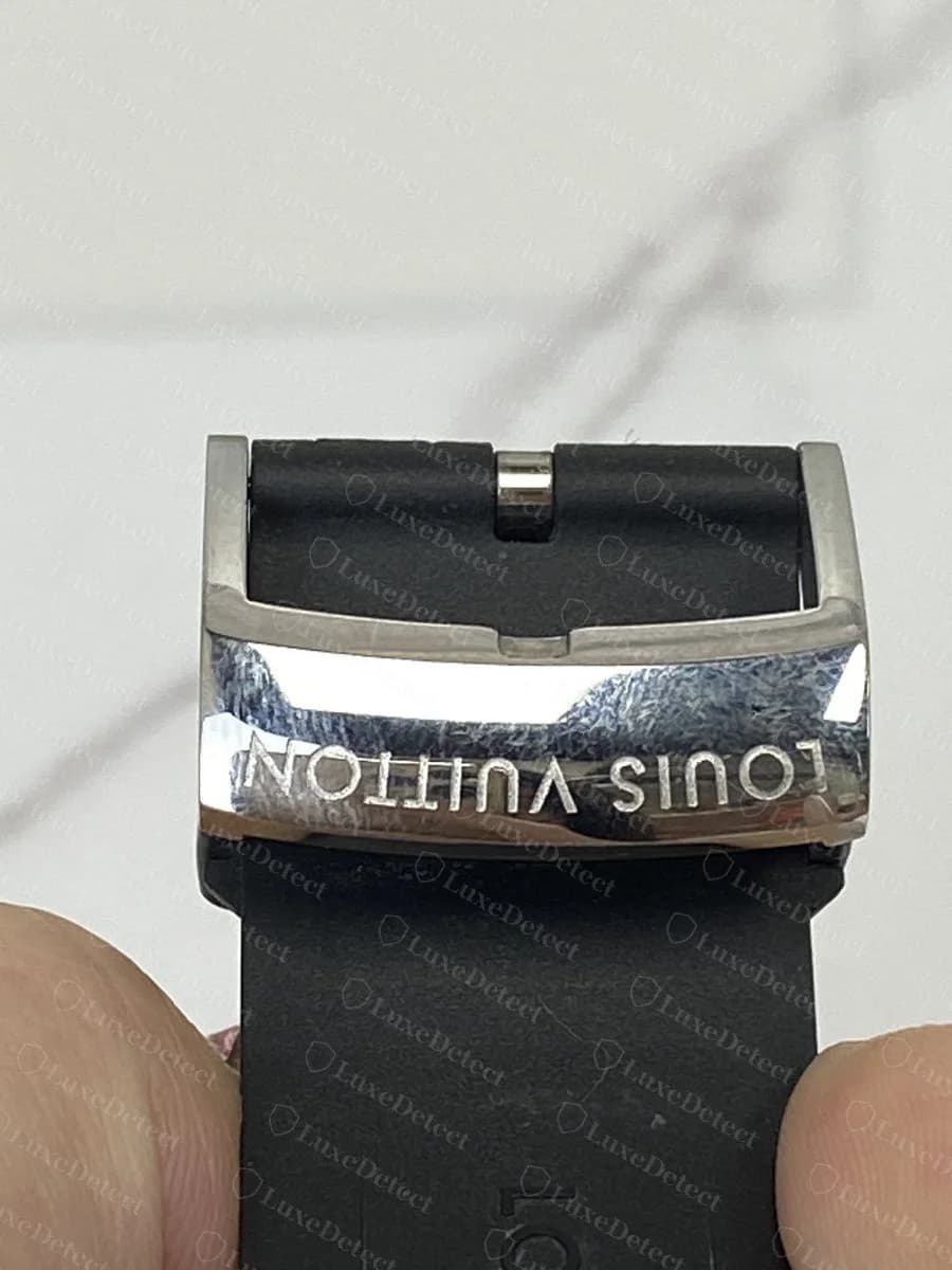 Authentic Louis Vuitton buckle engraving, "LOUIS VUITTON" stamped cleanly and legibly into the polished steel