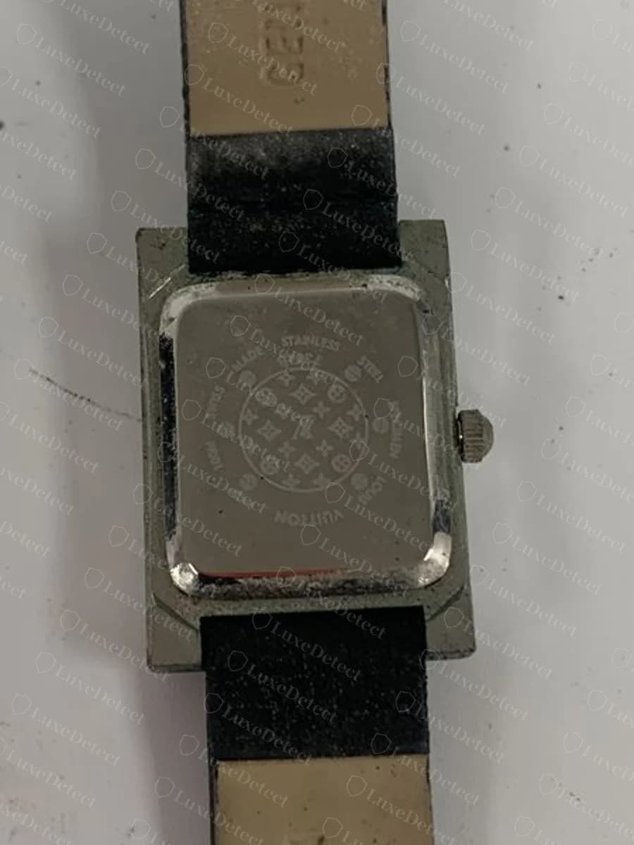 Counterfeit Louis Vuitton watch caseback reading "STAINLESS STEEL SPECIMEN 100M SWISS MADE" around a monogram-flower medallion, "specimen" being showroom-sample language never expected on a retail watch