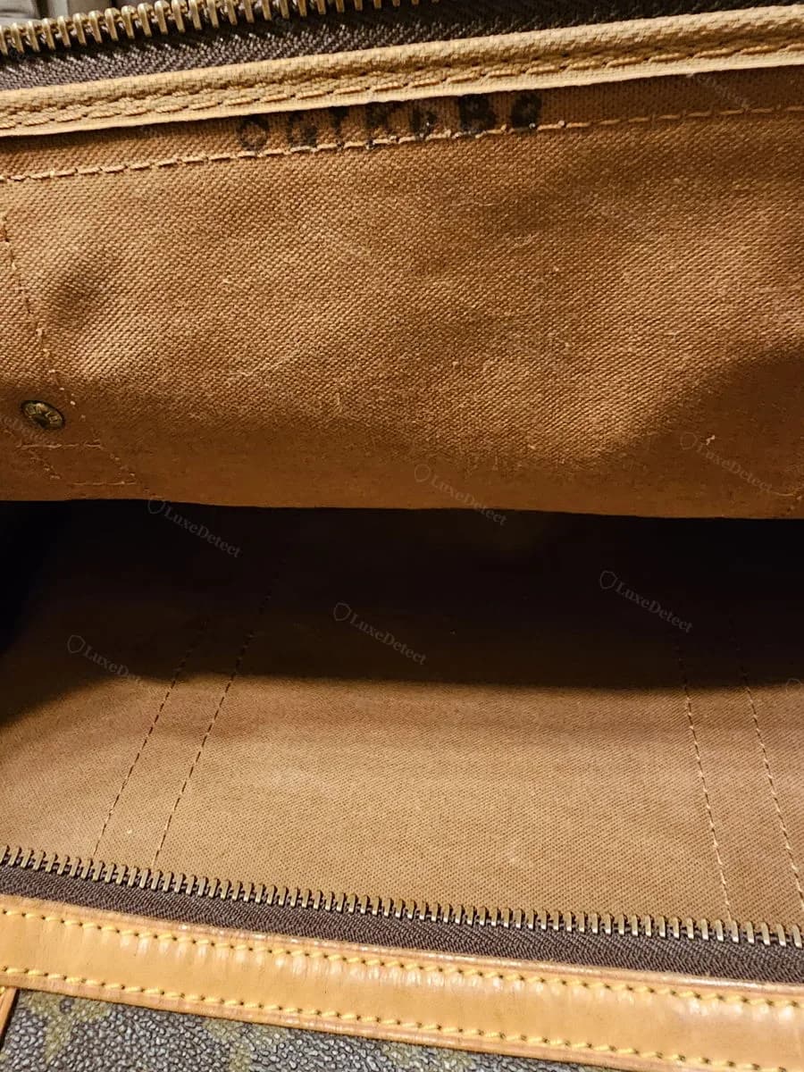 Interior stamp on a counterfeit Keepall in our archive — the characters do not resolve into a valid two-letter, four-digit LV date code
