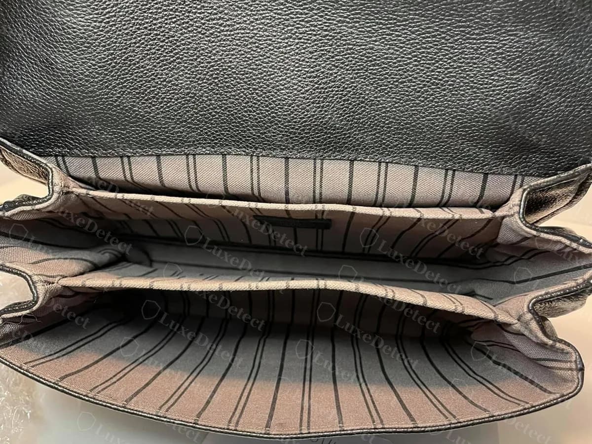 Genuine interior of a black Empreinte Metis opened up: a striped lining and separate compartments
