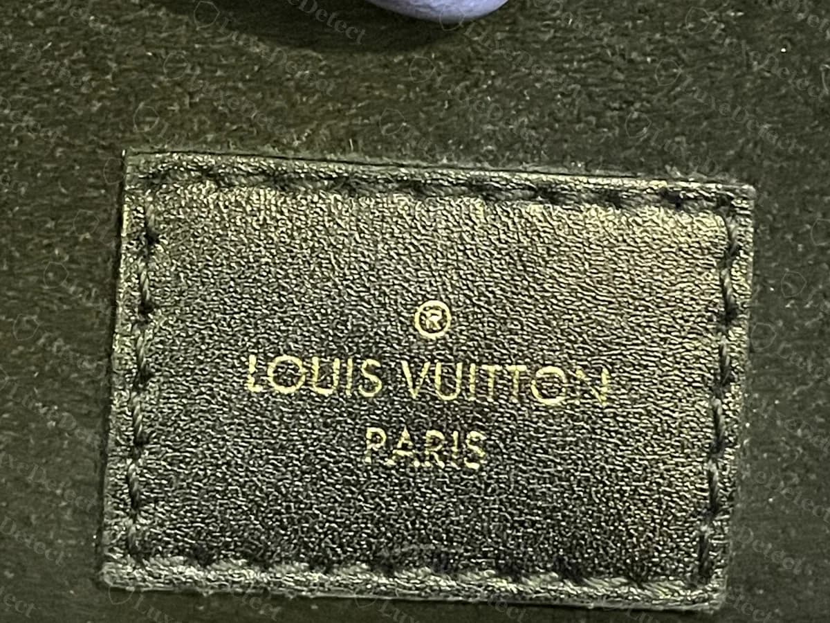 Genuine stitched interior tab on a black Empreinte Metis: the registered mark above "LOUIS VUITTON" and "PARIS", with no country line on this tab
