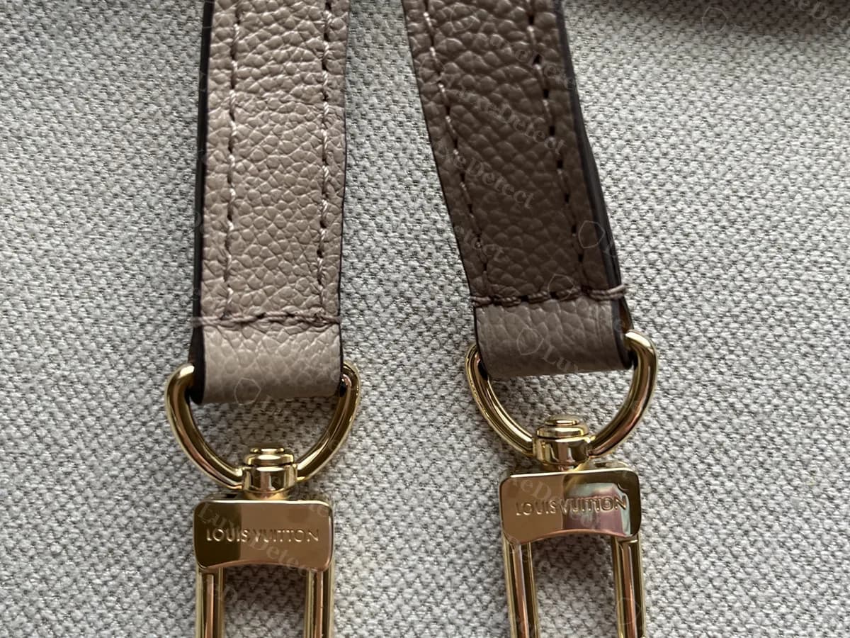 Genuine Metis strap ends: two gold-tone swivel clasps stamped LOUIS VUITTON on grained grey leather