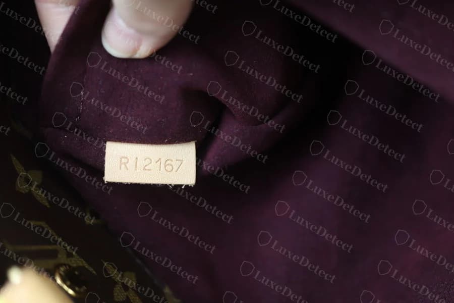 Authentic Monogram canvas Montaigne interior, showing the plain suede-look lining used on this material, distinct from the Empreinte's pinstripe toile