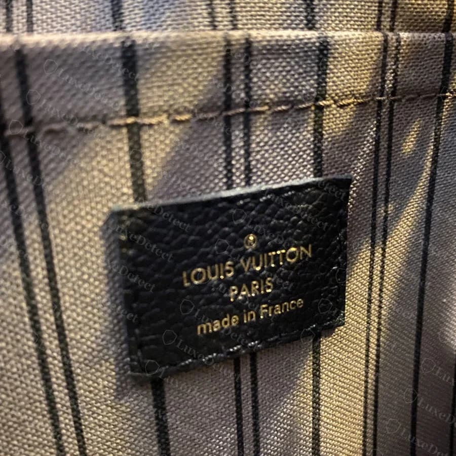 Authentic Empreinte Montaigne interior, showing the tonal pinstripe toile lining color-matched to the exterior, with the leather stamp tab
