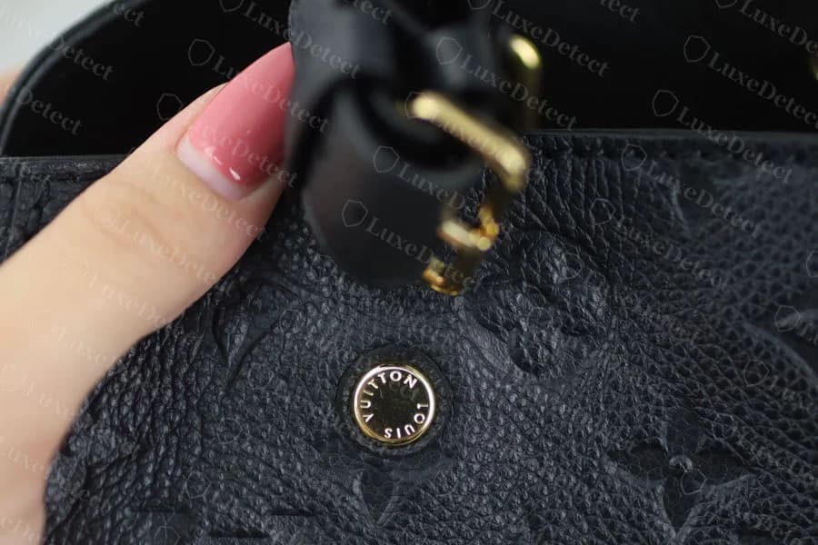 Authentic base stud with evenly spaced "LOUIS VUITTON" lettering struck at a consistent depth around a true round dome