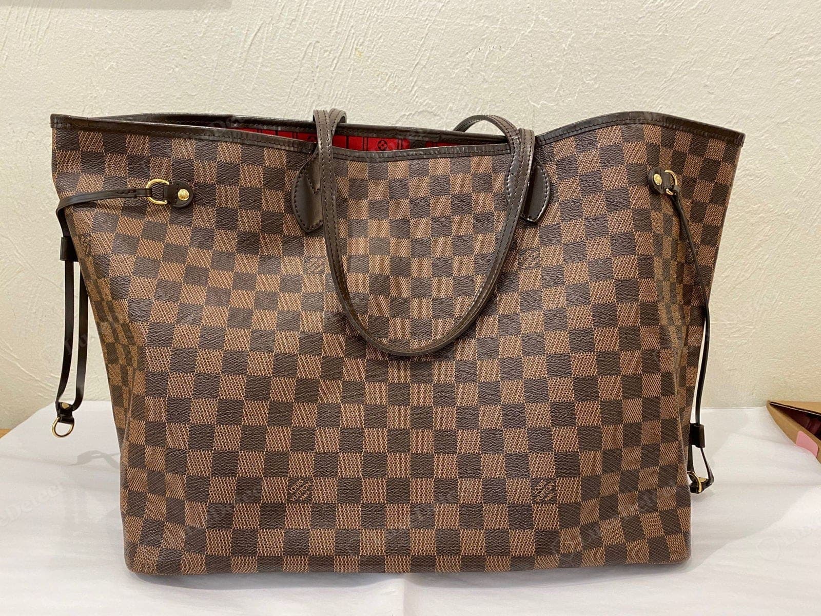 A vintage Louis Vuitton Damier Ebene tote, the kind of appreciating piece worth insuring at current market value