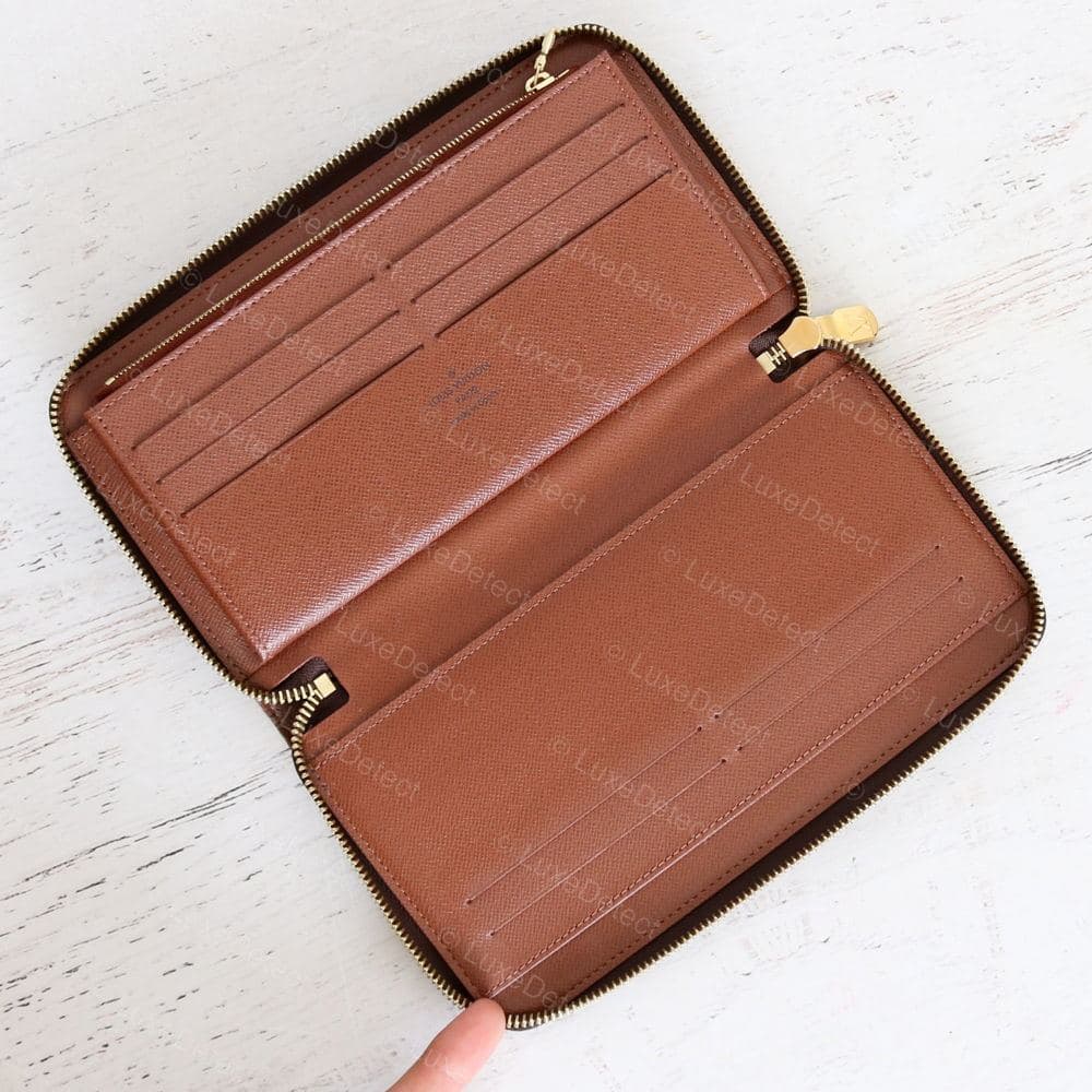 Genuine LV interior — supple tan cowhide, card slots with clean top edges, mustard-yellow stitching, and the brand stamp visible on the upper flap