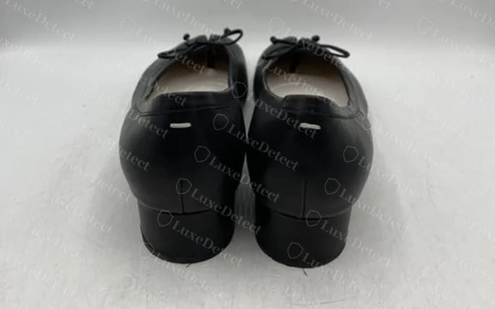 Genuine Maison Margiela Tabi block-heel flat seen from behind, with a small white stitched bar centred on the leather at the top of each heel